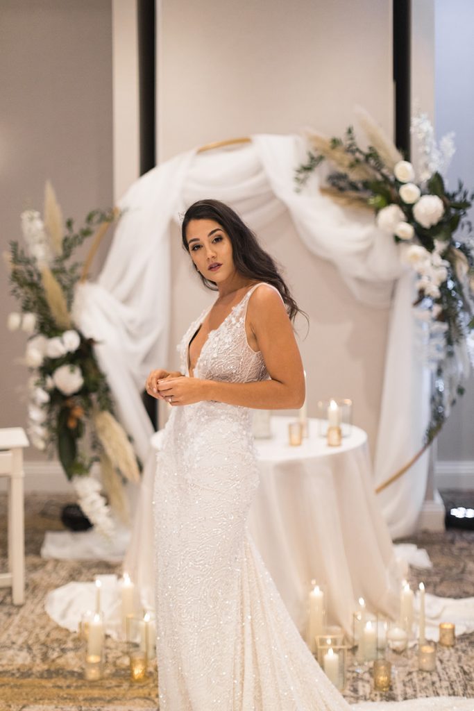 A sparkling and intricately detailed close up of an Inbal Dror wedding dress