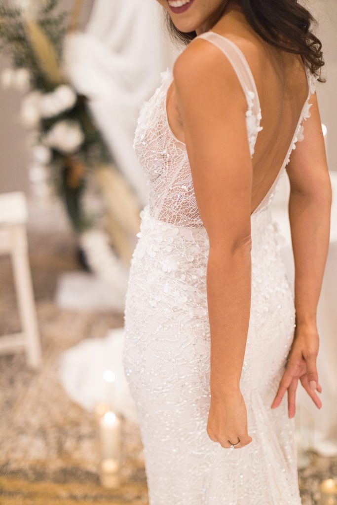 A sparkling and intricately detailed close up of an Inbal Dror wedding dress