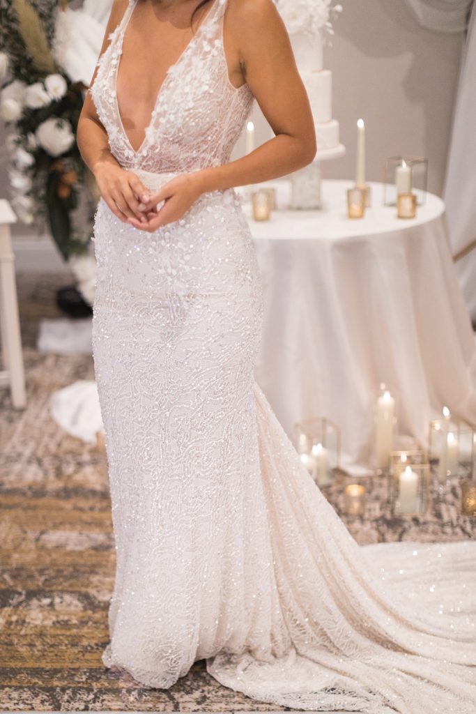 A sparkling and intricately detailed close up of an Inbal Dror wedding dress