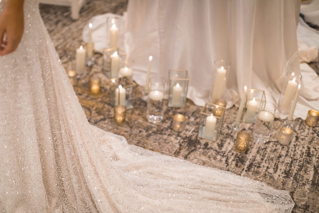 A sparkling and intricately detailed close up of an Inbal Dror wedding dress