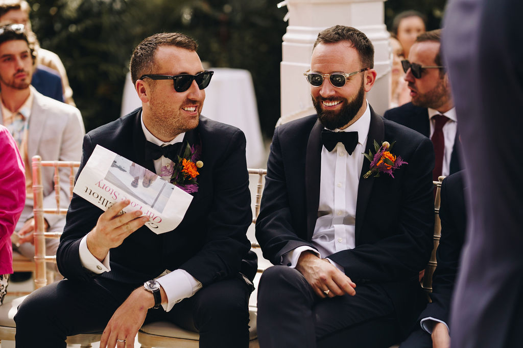 Grooms men enjoy reading the personalised song sheet during Grace + Elliott's wedding ceremony