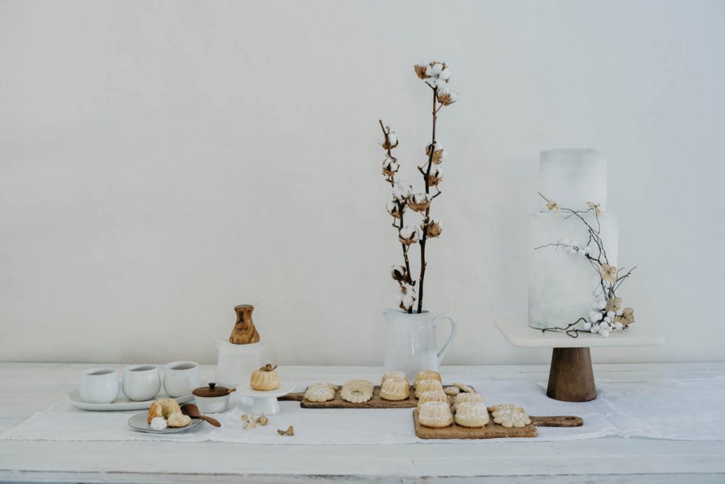 Scandinavian style dessert table with wooden accents in a clean, minimalist style