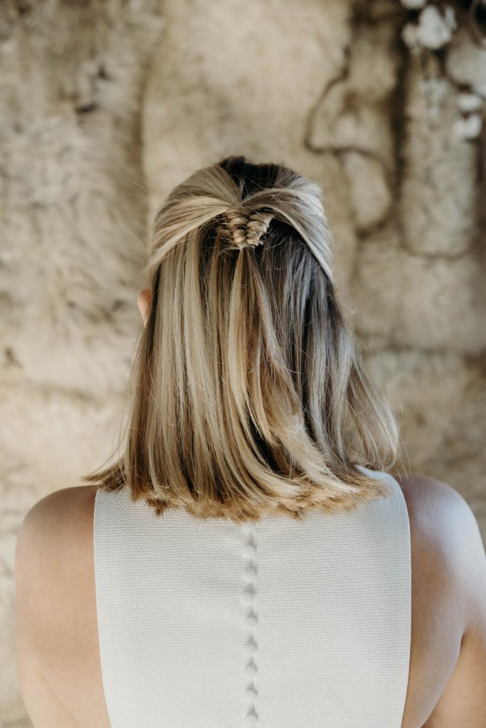 A modern half up half down hair style with a twist for a contemporary bride