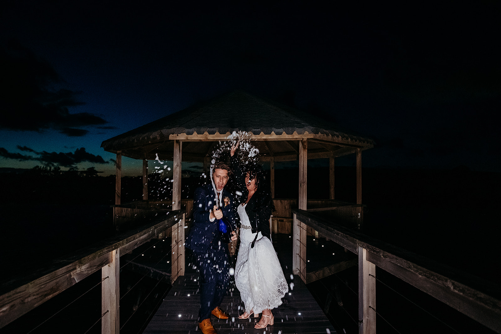 Champagne shot at dusk for newly married bride and groom at Quantock Lakes