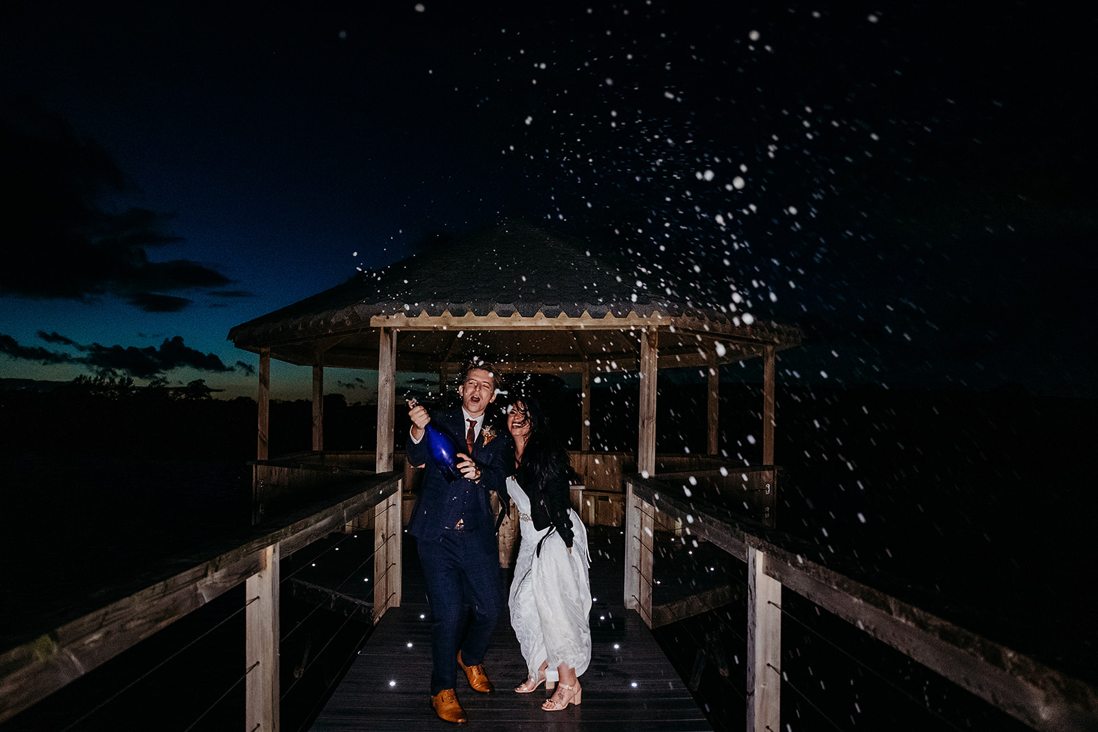Champagne shot at dusk for newly married bride and groom at Quantock Lakes