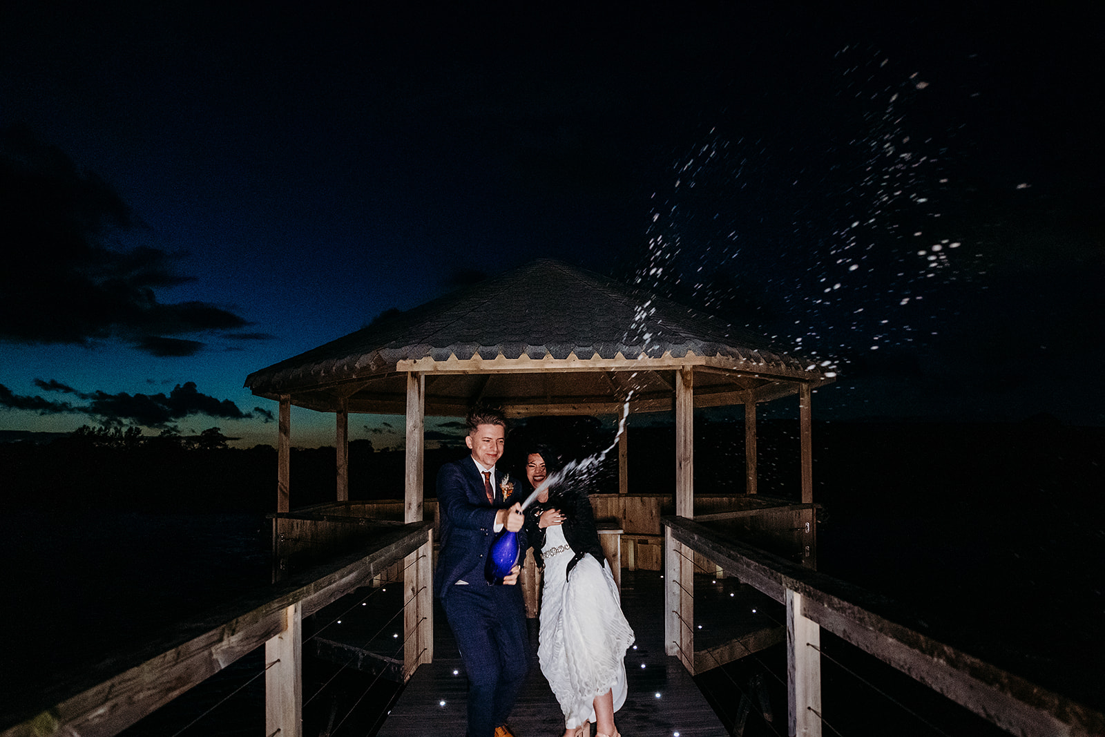 Champagne shot at dusk for newly married bride and groom at Quantock Lakes