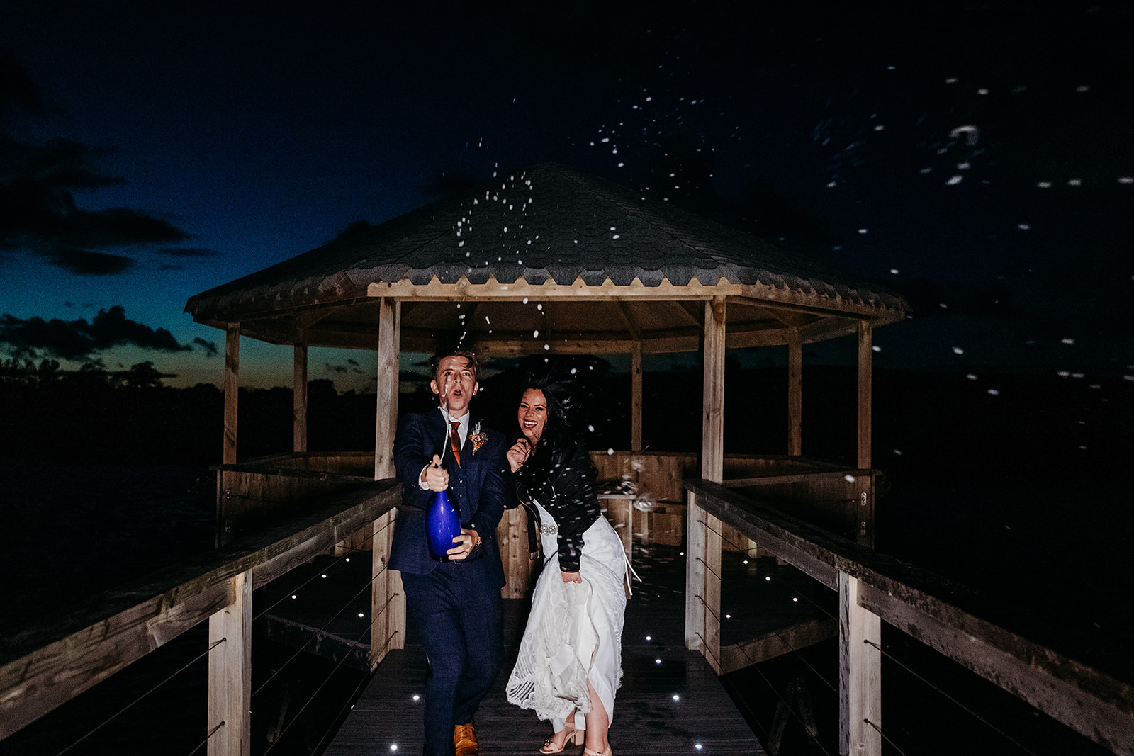 Champagne shot at dusk for newly married bride and groom at Quantock Lakes