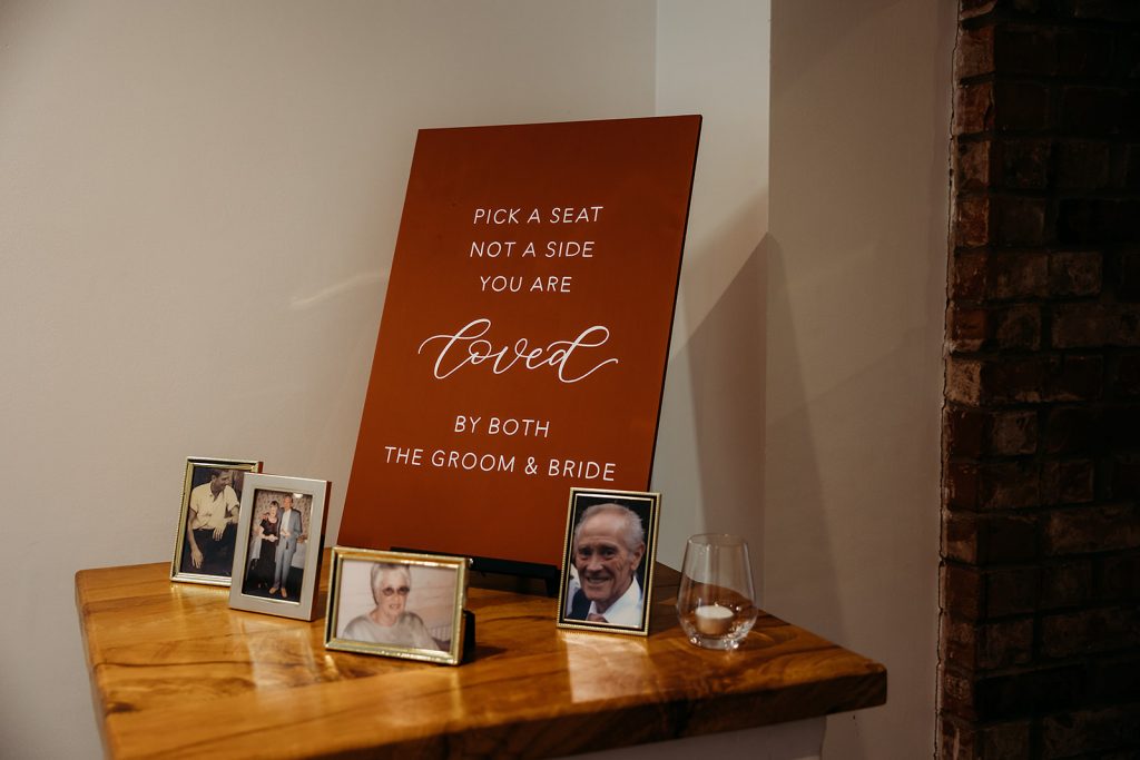 Pick a seat not a side wedding sign displayed on a memory table for Autumn boho wedding