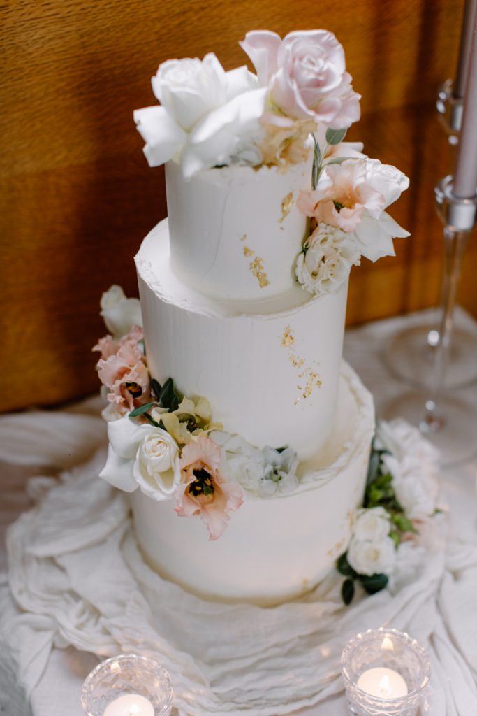 An elegant three tiered white wedding cake for a winter wedding at Bishops Stortford College