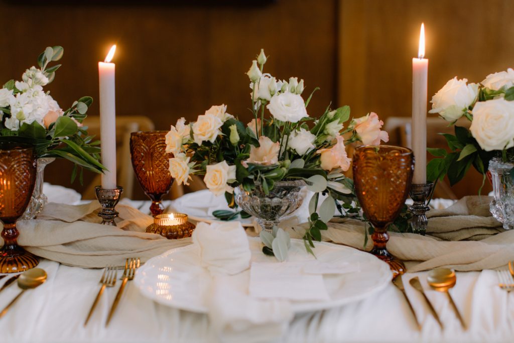 Elegant white fine china plate wear setting the scene for an elegant winter wedding table set up