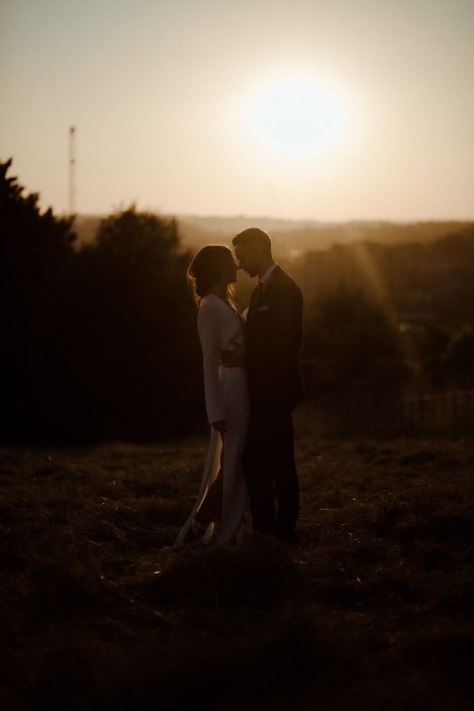 A intimate sunset moment for two newly weds on their wedding day