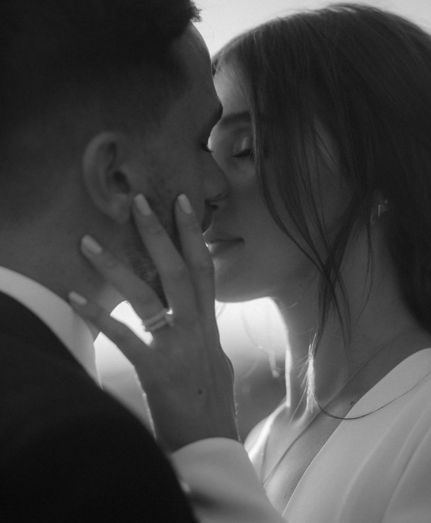 A tender moment between a bride and groom during their city elopement