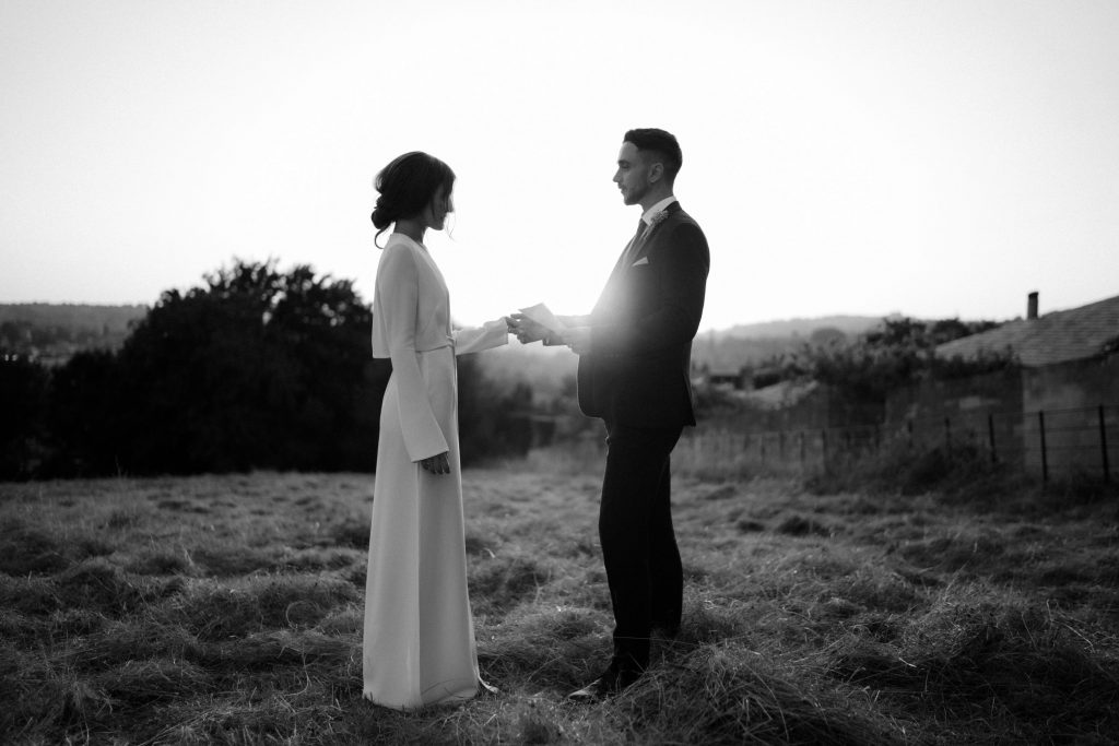 A couple eloping in the city of Bath say their vows to each other during sunset in an intimate elopement