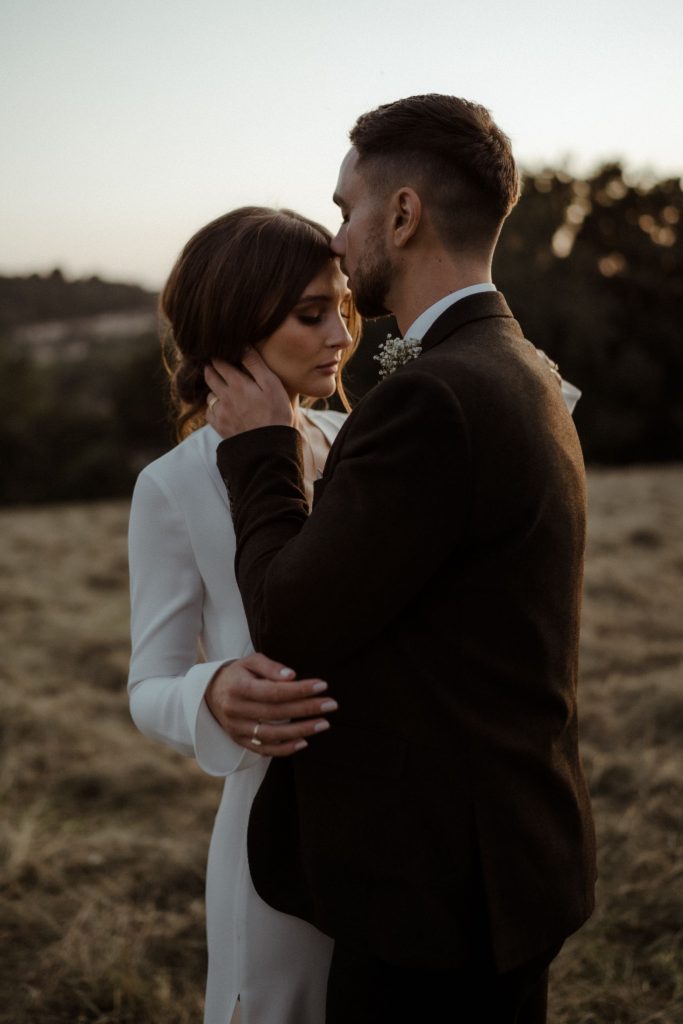 A intimate sunset moment for two newly weds on their wedding day