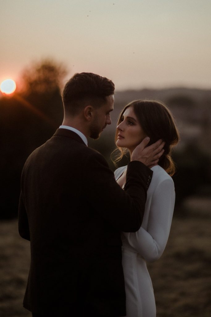 A intimate sunset moment for two newly weds on their wedding day