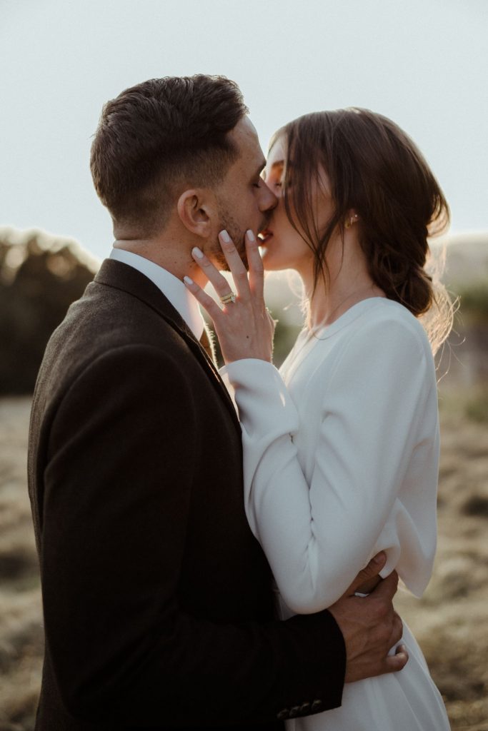 A tender moment between a bride and groom during their city elopement