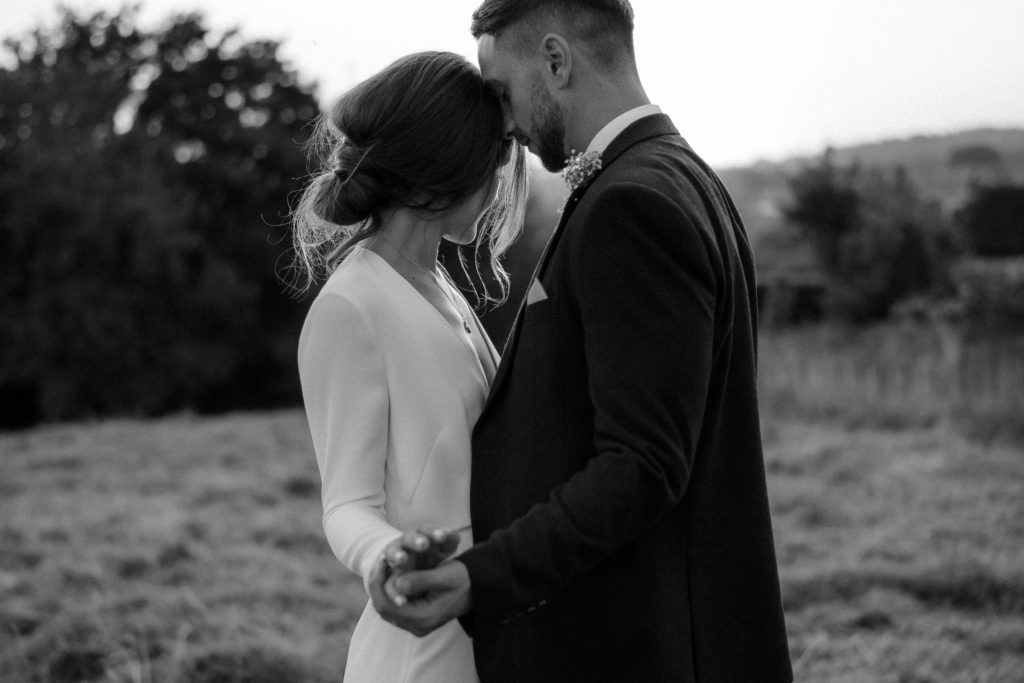 A tender moment between a bride and groom during their city elopement