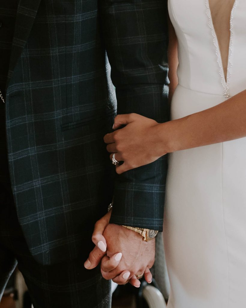 A bride holds tightly onto her soon to be husband during their emotional wedding ceremony