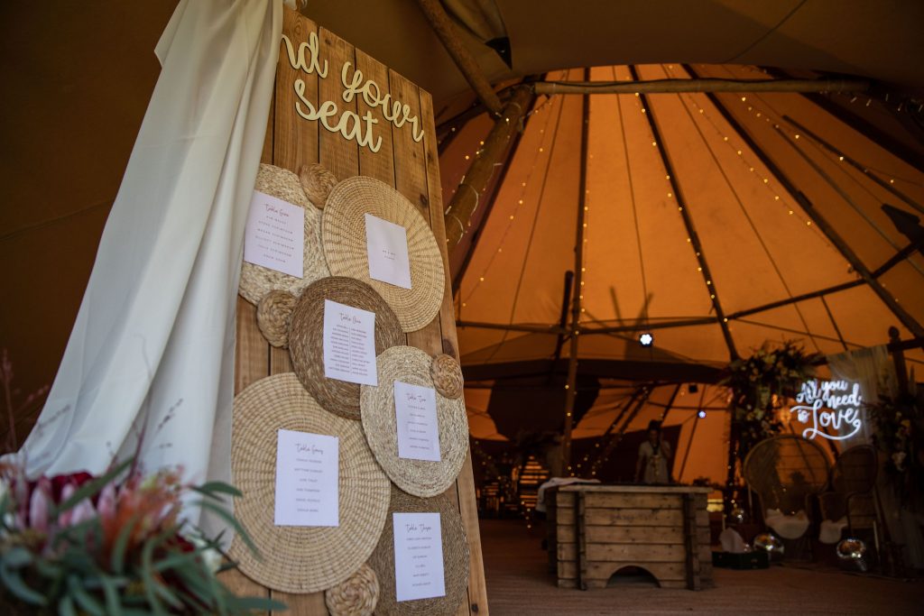 Rattan style wedding table plan for tipi wedding