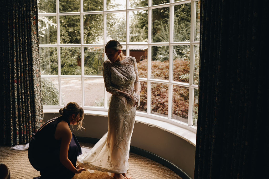 Beautiful bride in a long sleeved, high neck, embellished Yolancris wedding gown