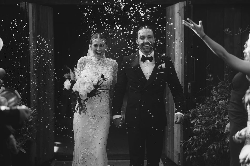 Beautiful bride in a long sleeved, high neck, embellished Yolancris wedding gown