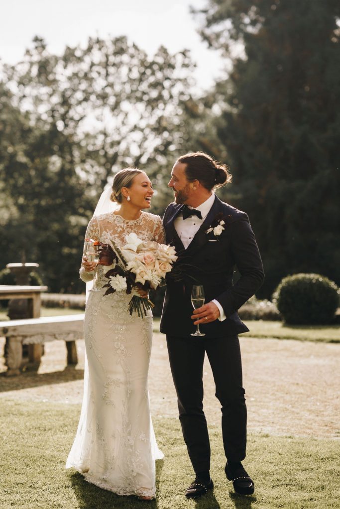 Beautiful bride in a long sleeved, high neck, embellished Yolancris wedding gown