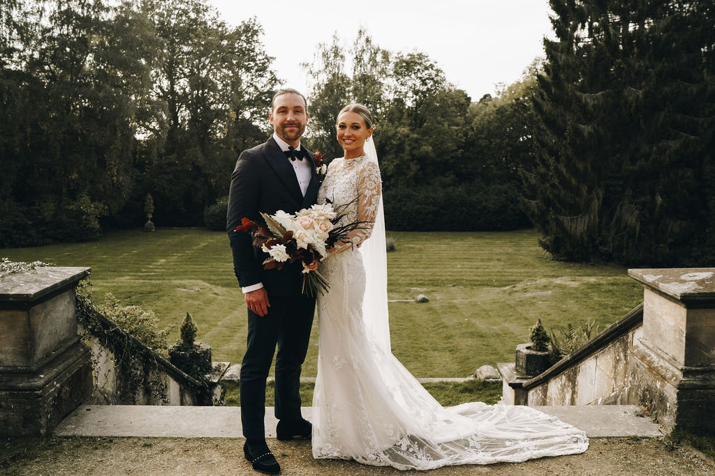 Beautiful bride in a long sleeved, high neck, embellished Yolancris wedding gown