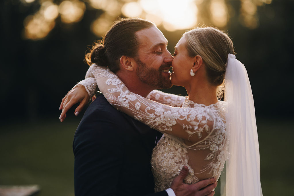 Beautiful bride in a long sleeved, high neck, embellished Yolancris wedding gown