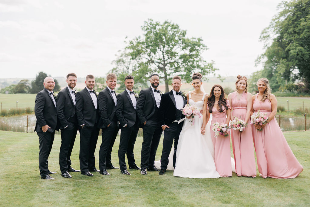 An elegant pink and gold wedding at Davenport House with two Milla Nova dresses