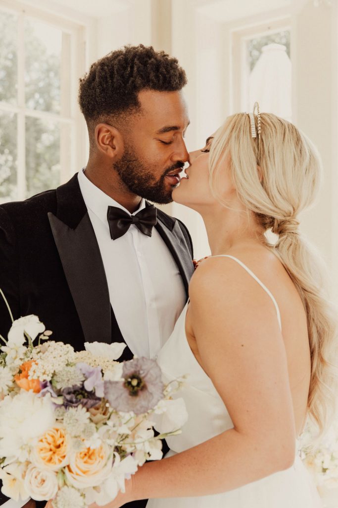 A tender kiss for Kezia + Jordan captured by Emma Wilkinson Photography
