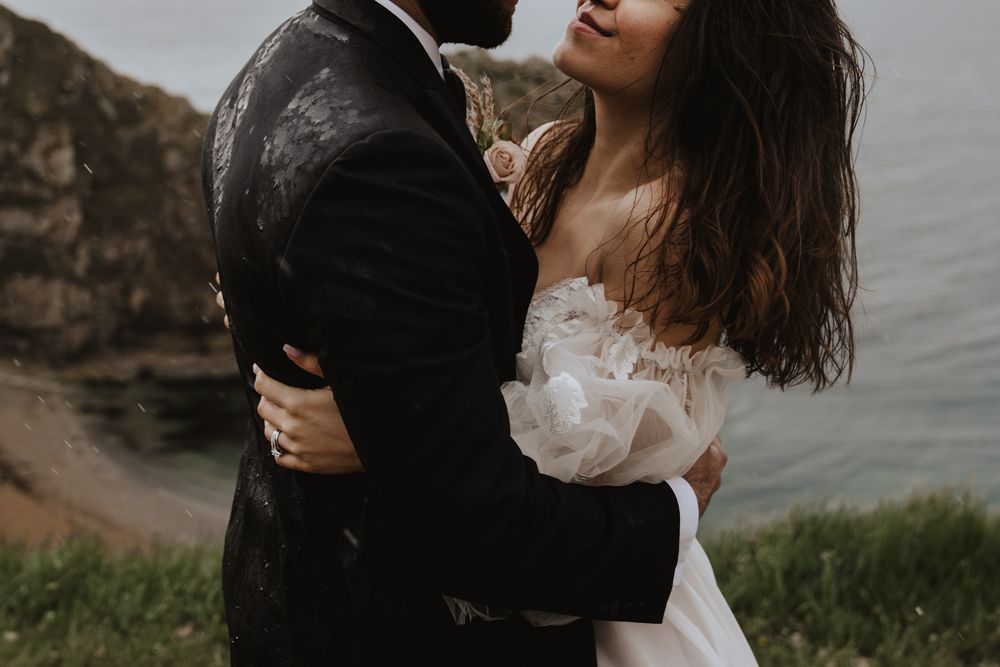 A bespoke wedding dress for a barefoot bohemian bride and a rainy beach elopement