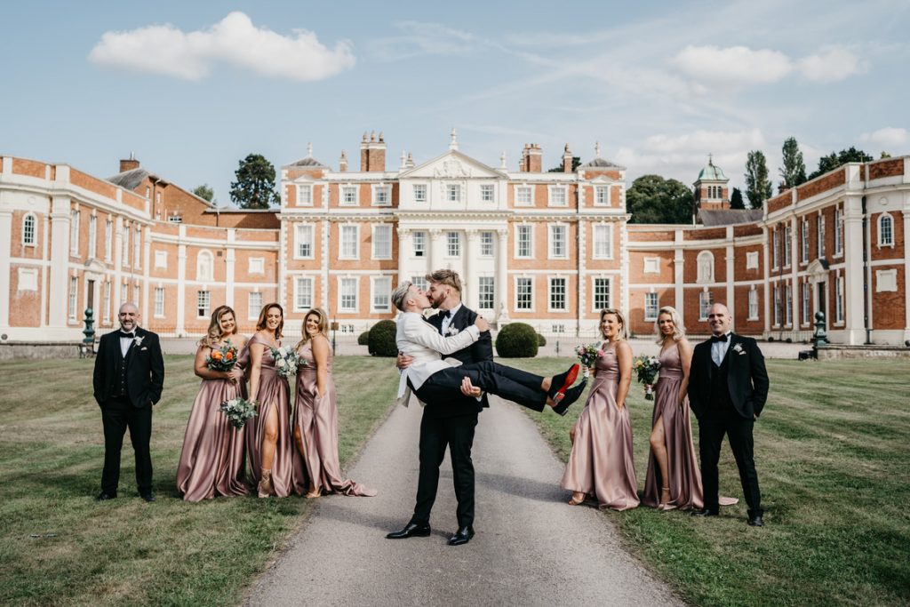 A kiss for the newlyweds outside the grandeur of Hawkstone Hall | David Boynton Photography