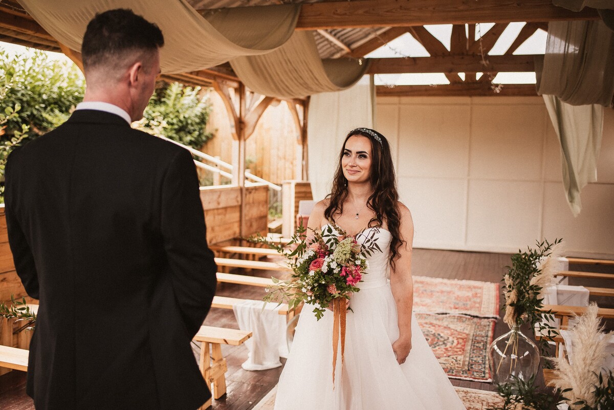 Boho luxe wedding ceremony styling within a modern bran style ceremony space