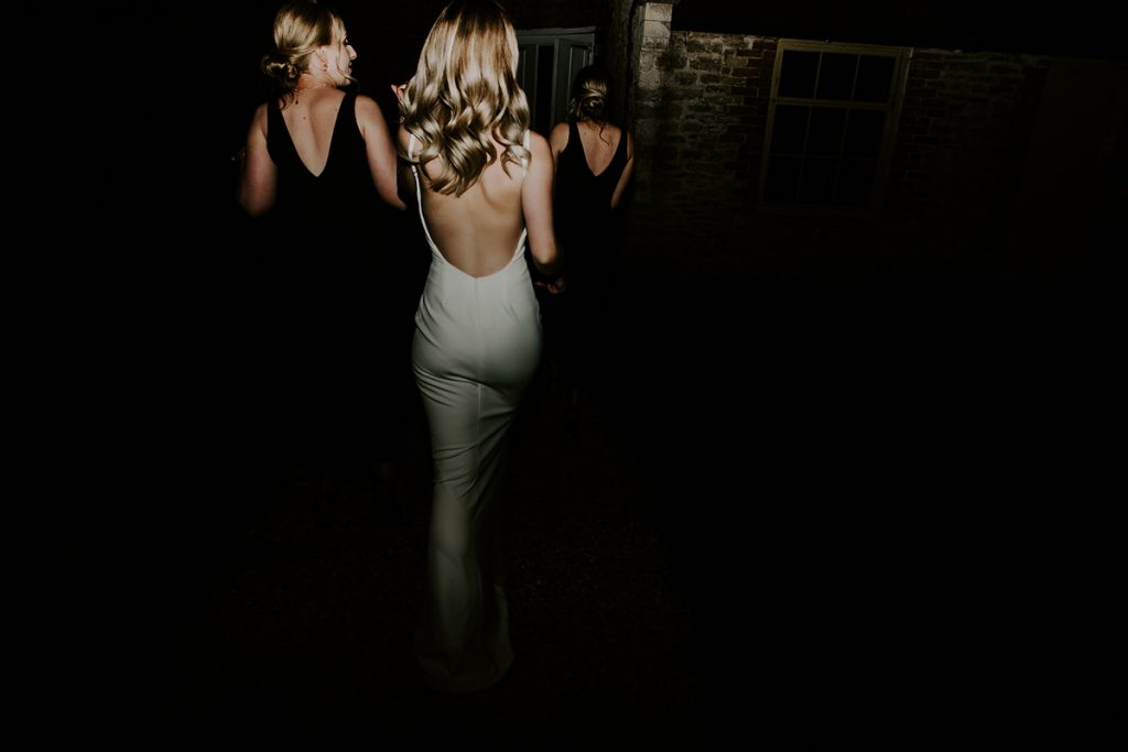 An evening outfit change for Elmhay Park bride into a minimalist wedding slip for a chic, elegant party look