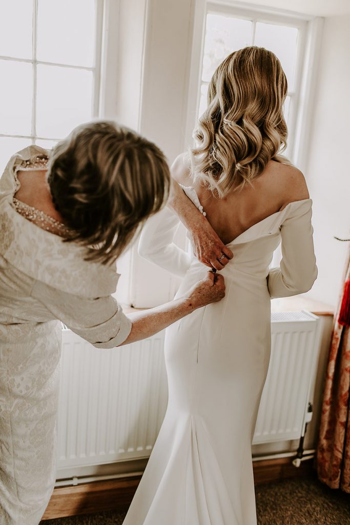 Minimalist wedding style for bride Sophie in a long sleeved Milla Nova dress