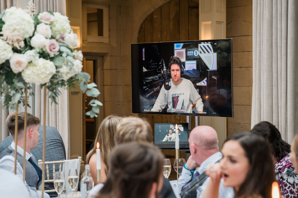 A surprise 'appearance' from Radio 1's Greg James for Jessica + Luke's wedding day at Hampton Manor