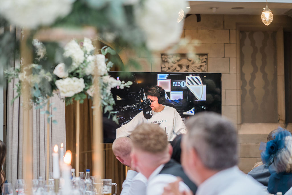 A surprise 'appearance' from Radio 1's Greg James for Jessica + Luke's wedding day at Hampton Manor