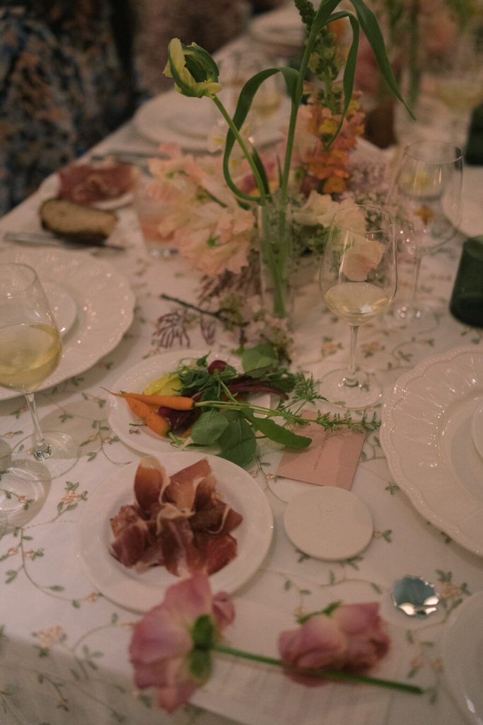 Guests gather around a beautifully styled table of spring blooms and carefully designed details, from a tasting menu featuring oysters, fresh farm vegetables and a selection of cured meats.