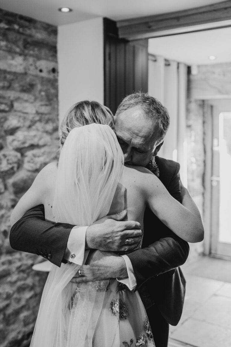 Paige + Ash's wedding day at Dodford Manor featuring a colourful hand painted wedding dress by Savin London