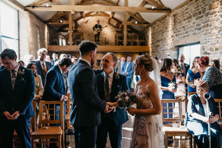 Paige + Ash's wedding day at Dodford Manor featuring a colourful hand painted wedding dress by Savin London