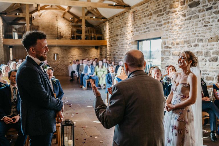 Paige + Ash's wedding day at Dodford Manor featuring a colourful hand painted wedding dress by Savin London