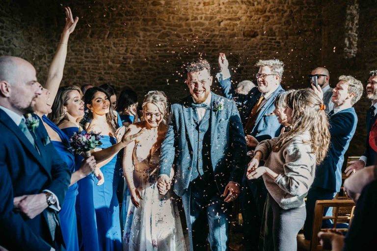 Paige + Ash's wedding day at Dodford Manor featuring a colourful hand painted wedding dress by Savin London