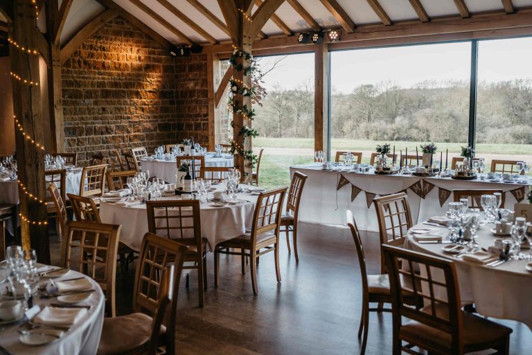Paige + Ash's wedding day at Dodford Manor featuring a colourful hand painted wedding dress by Savin London