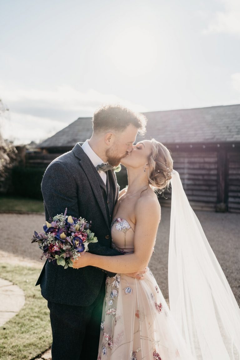 Paige + Ash's wedding day at Dodford Manor featuring a colourful hand painted wedding dress by Savin London