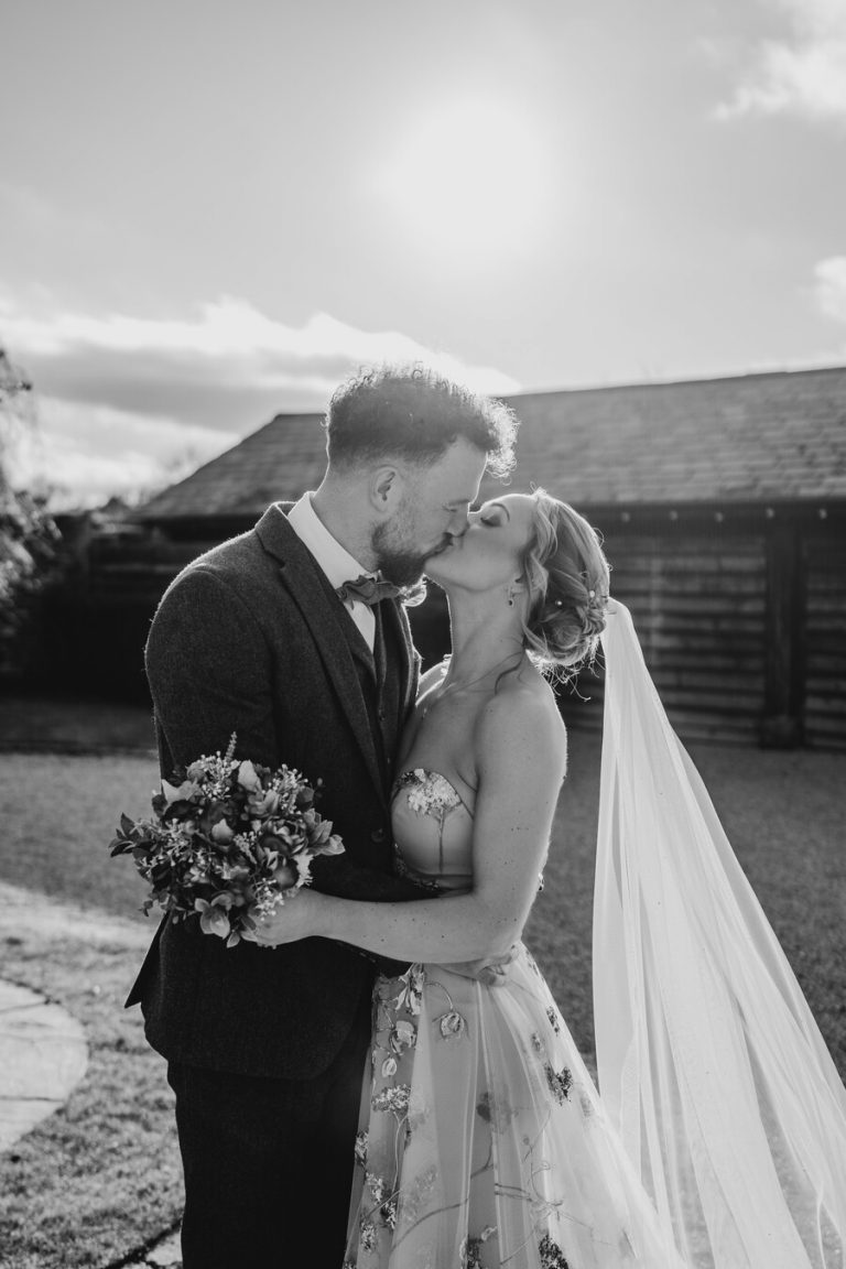 Paige + Ash's wedding day at Dodford Manor featuring a colourful hand painted wedding dress by Savin London
