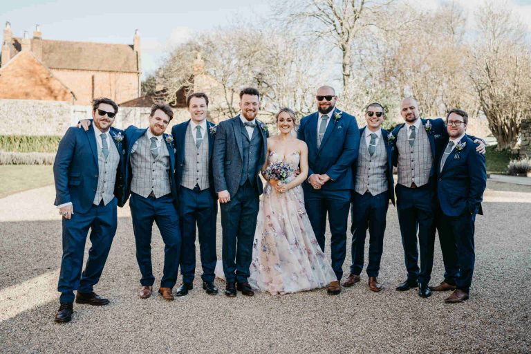 Paige + Ash's wedding day at Dodford Manor featuring a colourful hand painted wedding dress by Savin London