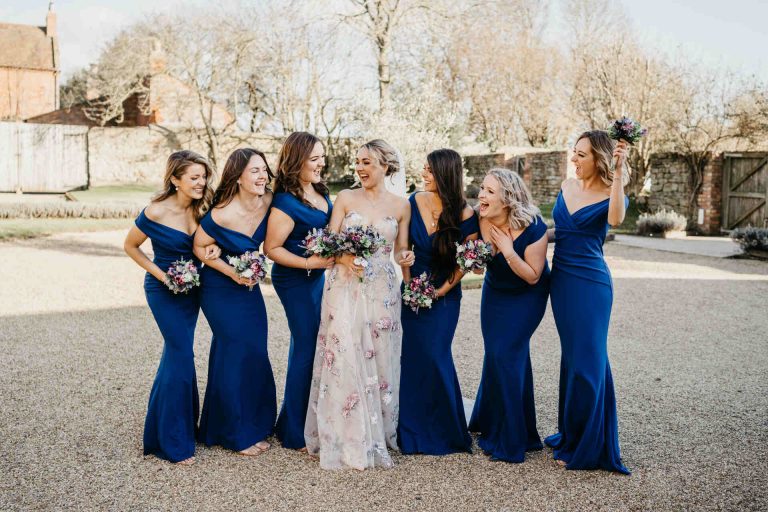 Paige + Ash's wedding day at Dodford Manor featuring a colourful hand painted wedding dress by Savin London