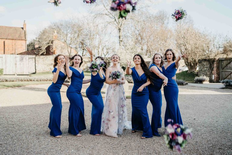 Paige + Ash's wedding day at Dodford Manor featuring a colourful hand painted wedding dress by Savin London