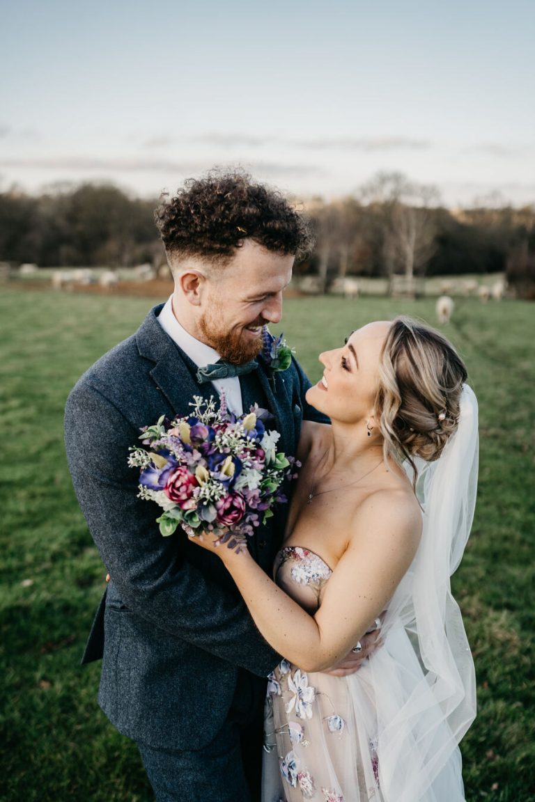 Paige + Ash's wedding day at Dodford Manor featuring a colourful hand painted wedding dress by Savin London