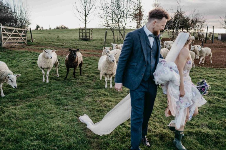 Paige + Ash's wedding day at Dodford Manor featuring a colourful hand painted wedding dress by Savin London